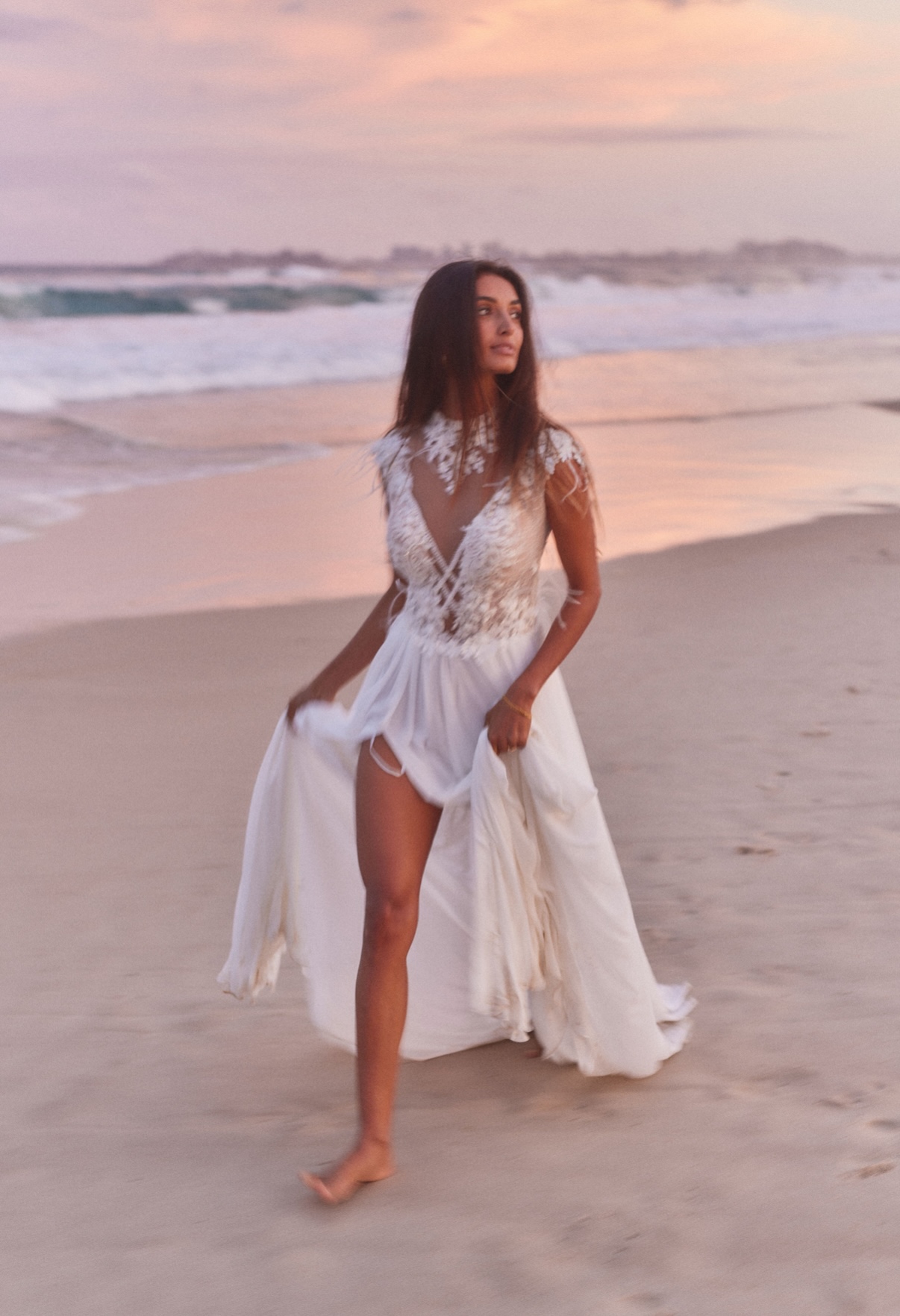 Alana McBain at the atelier with a dress on the hanger.